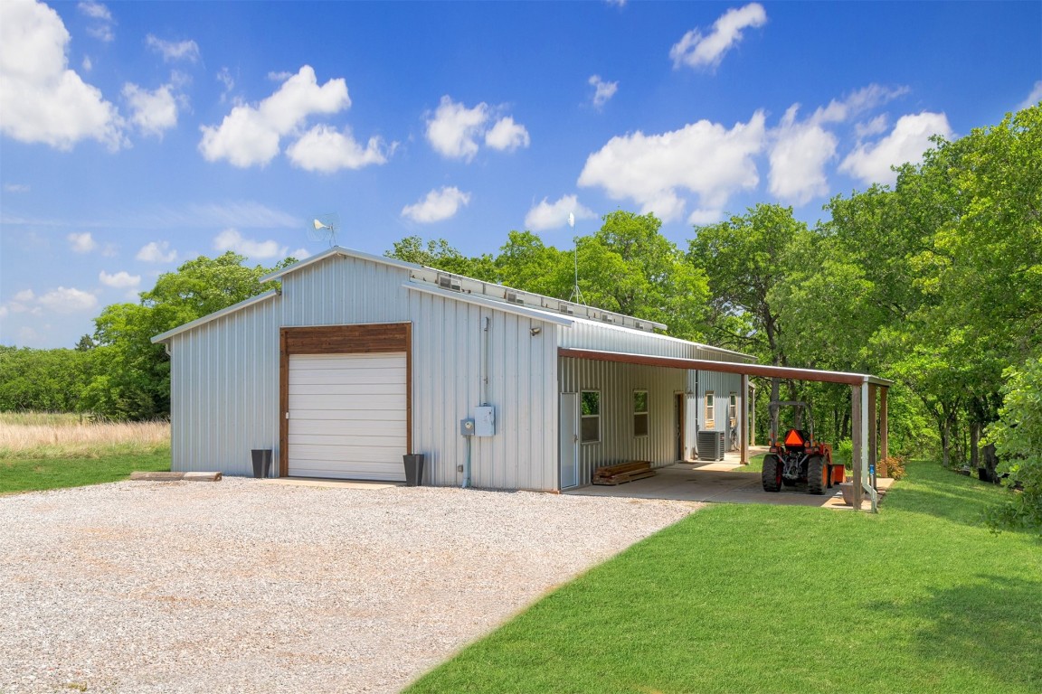 17000 N Anderson Road, Arcadia, OK 73007 garage with a carport and a yard