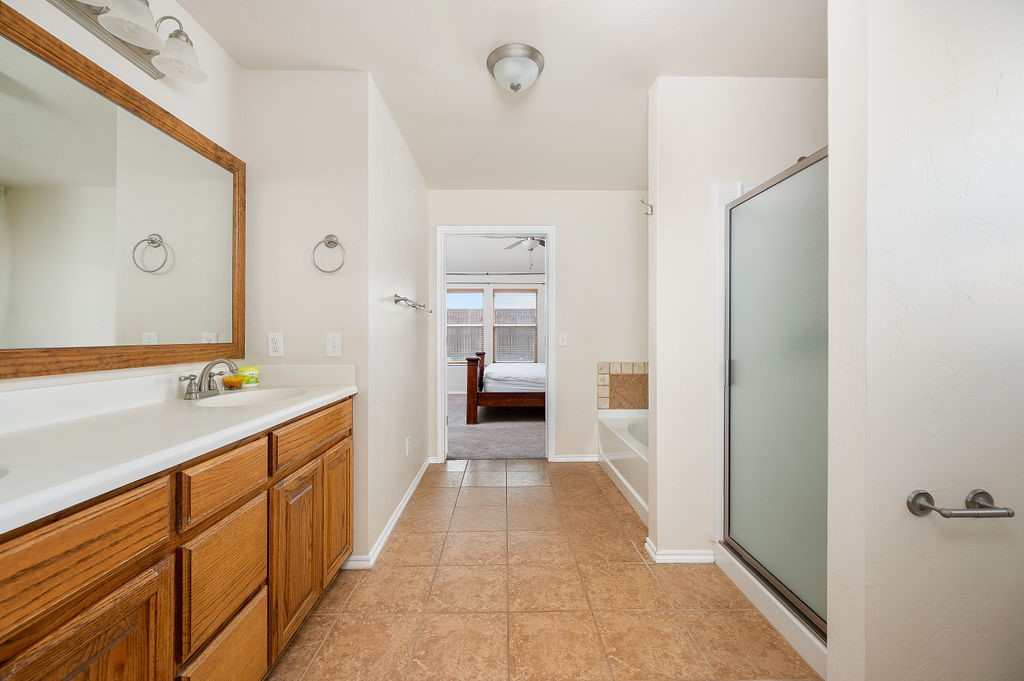 16420 Drywater Drive, Oklahoma City, OK 73170 bathroom featuring large vanity, dual sinks, toilet, and tile flooring