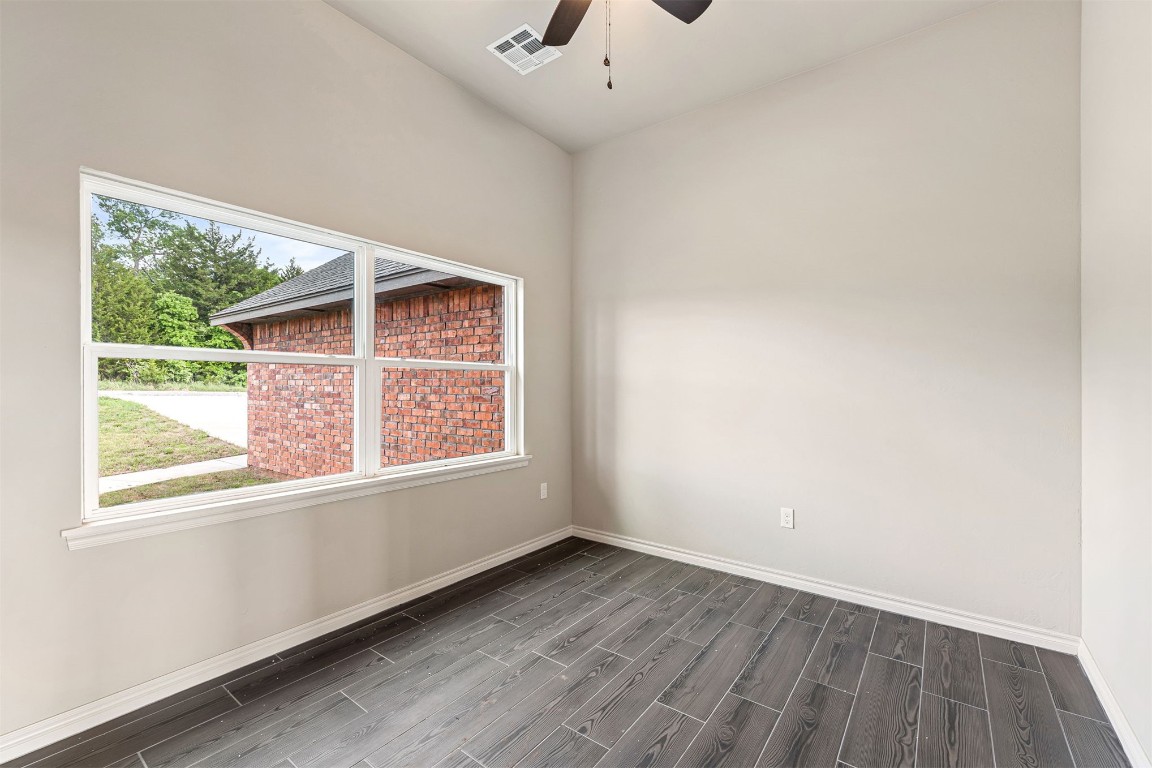 2268 S Murphys Ridge Road, Blanchard, OK 73010 spare room featuring ceiling fan and dark wood-type flooring
