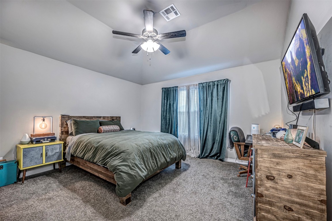 4112 Alnwick Lane, Oklahoma City, OK 73179 carpeted bedroom featuring ceiling fan and vaulted ceiling