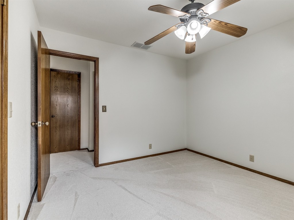 9610 Warringer Court, Oklahoma City, OK 73162 unfurnished room with light colored carpet and ceiling fan