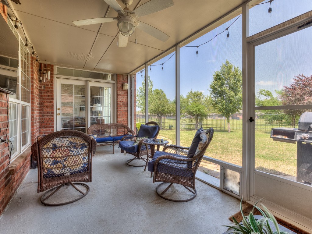 15608 Traditions Boulevard, Edmond, OK 73013 sunroom / solarium with ceiling fan and a healthy amount of sunlight