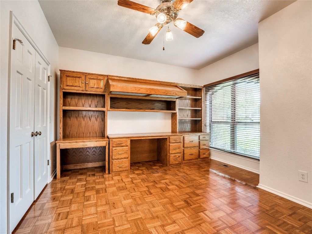 2501 Julies Trail, Edmond, OK 73012 unfurnished office with ceiling fan, light parquet floors, and a textured ceiling
