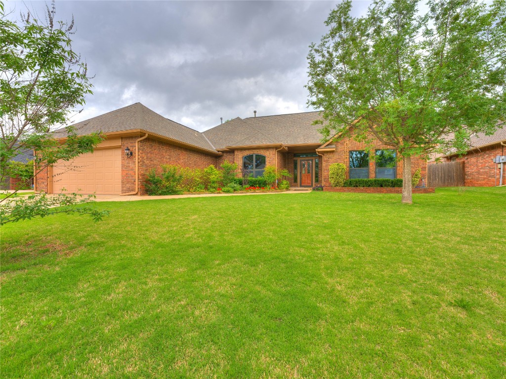 2501 Julies Trail, Edmond, OK 73012 single story home featuring a garage and a front lawn