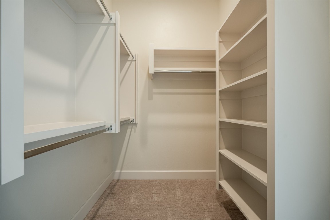 6309 Canopy Lane, Edmond, OK 73025 spacious closet featuring carpet floors
