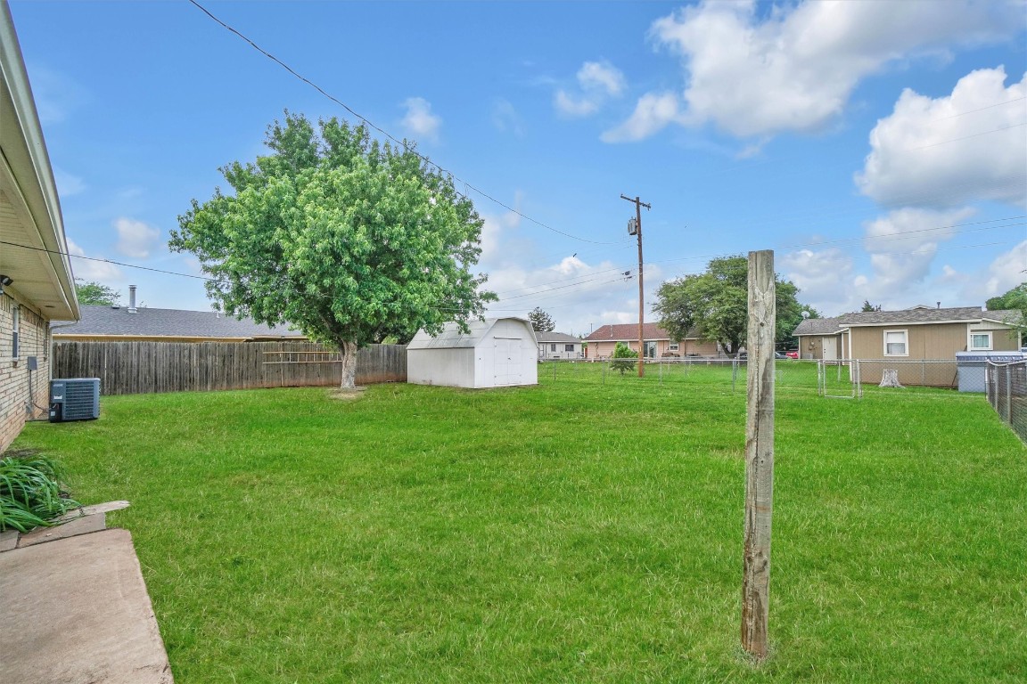 505 Libra Street, Altus, OK 73521 view of yard with central AC and a storage shed