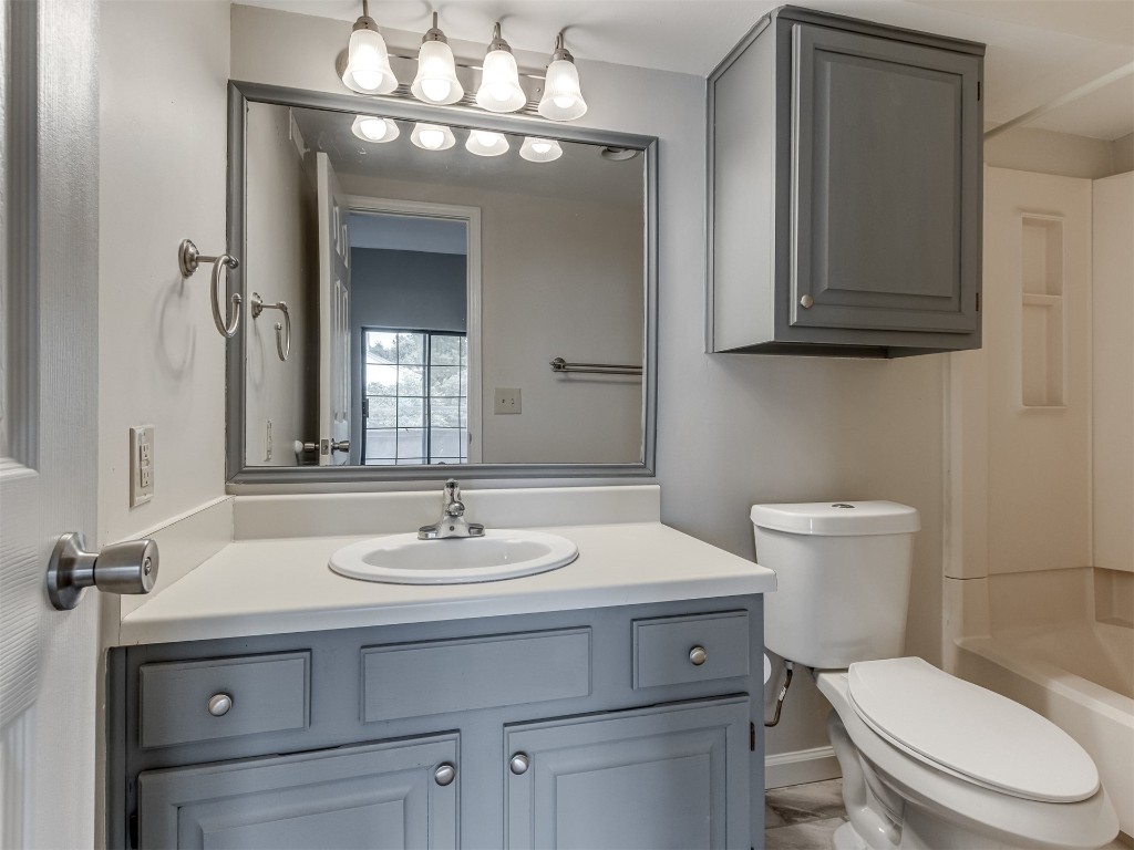 11130 Stratford Drive, #412, Oklahoma City, OK 73120 full bathroom with vanity, toilet, and shower / bathtub combination