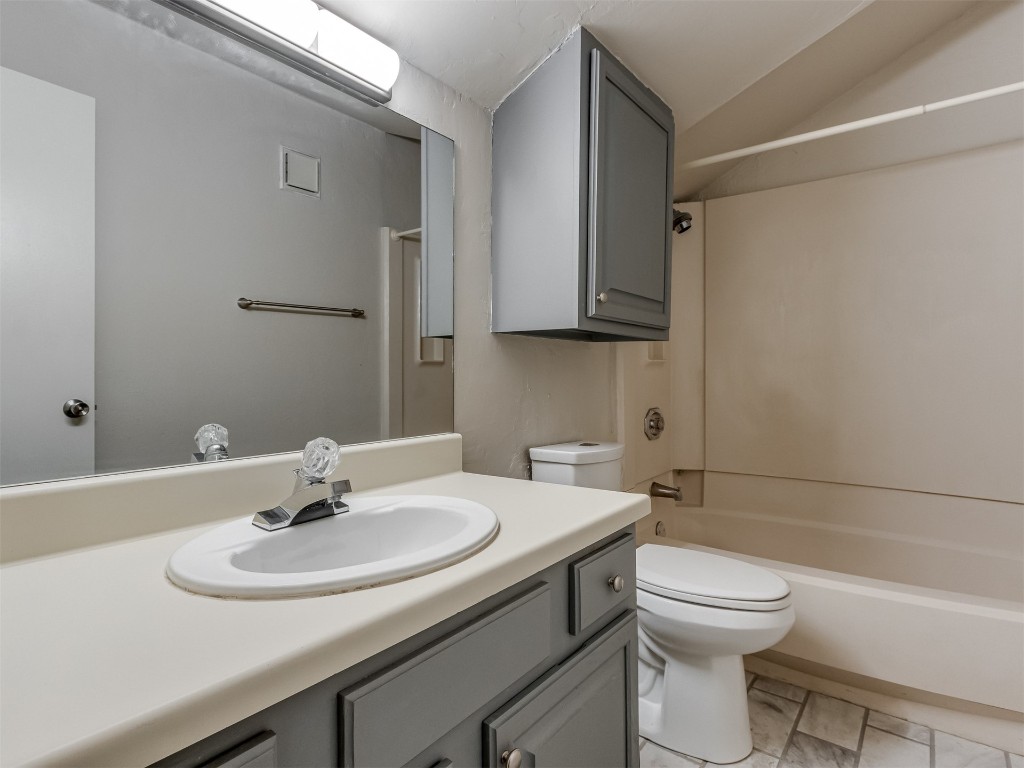 11130 Stratford Drive, #412, Oklahoma City, OK 73120 full bathroom featuring vanity with extensive cabinet space, toilet, tile floors, and bathing tub / shower combination