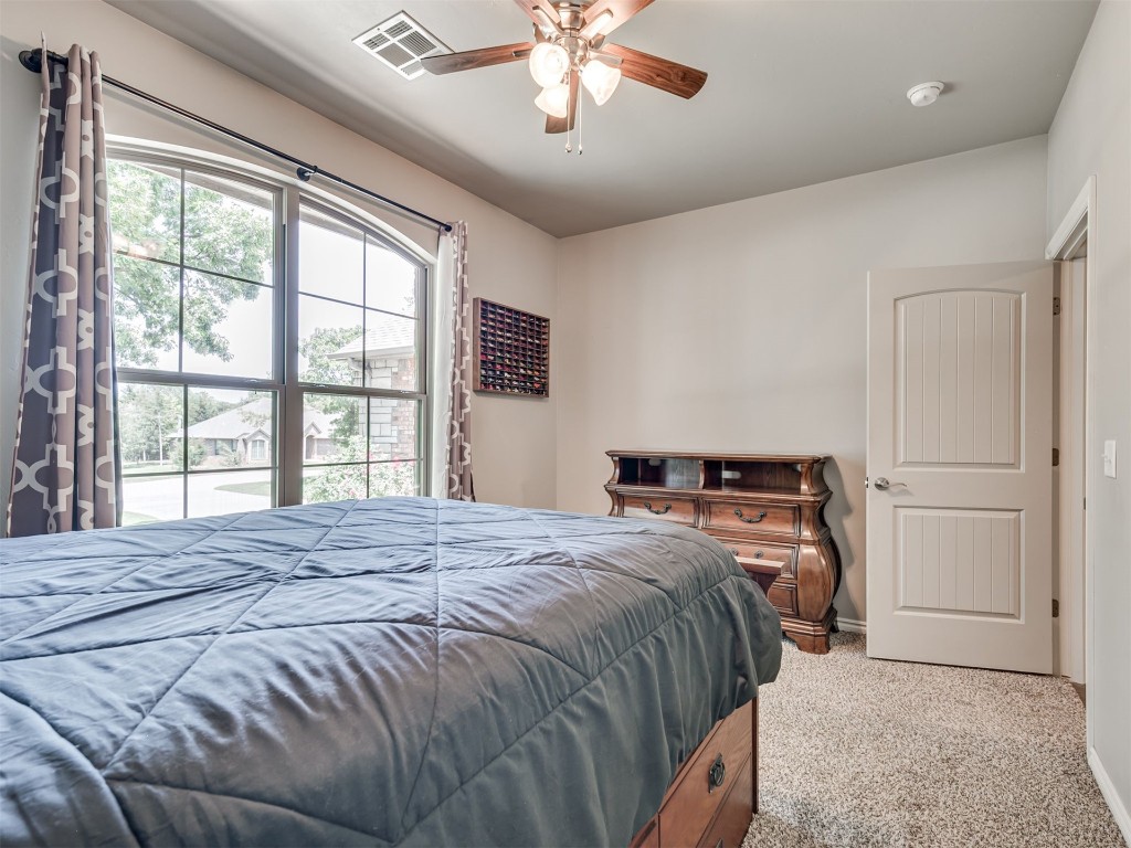 3367 Bobcat Trail, Guthrie, OK 73044 carpeted bedroom featuring multiple windows and ceiling fan