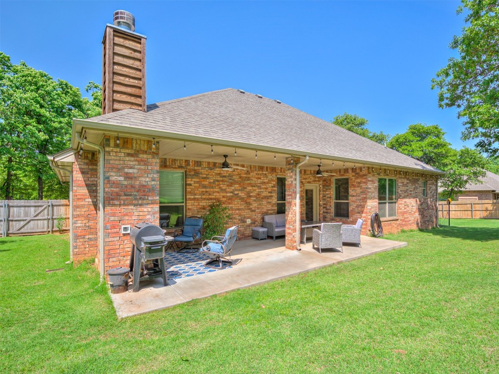 3367 Bobcat Trail, Guthrie, OK 73044 rear view of property featuring a lawn, ceiling fan, and a patio area