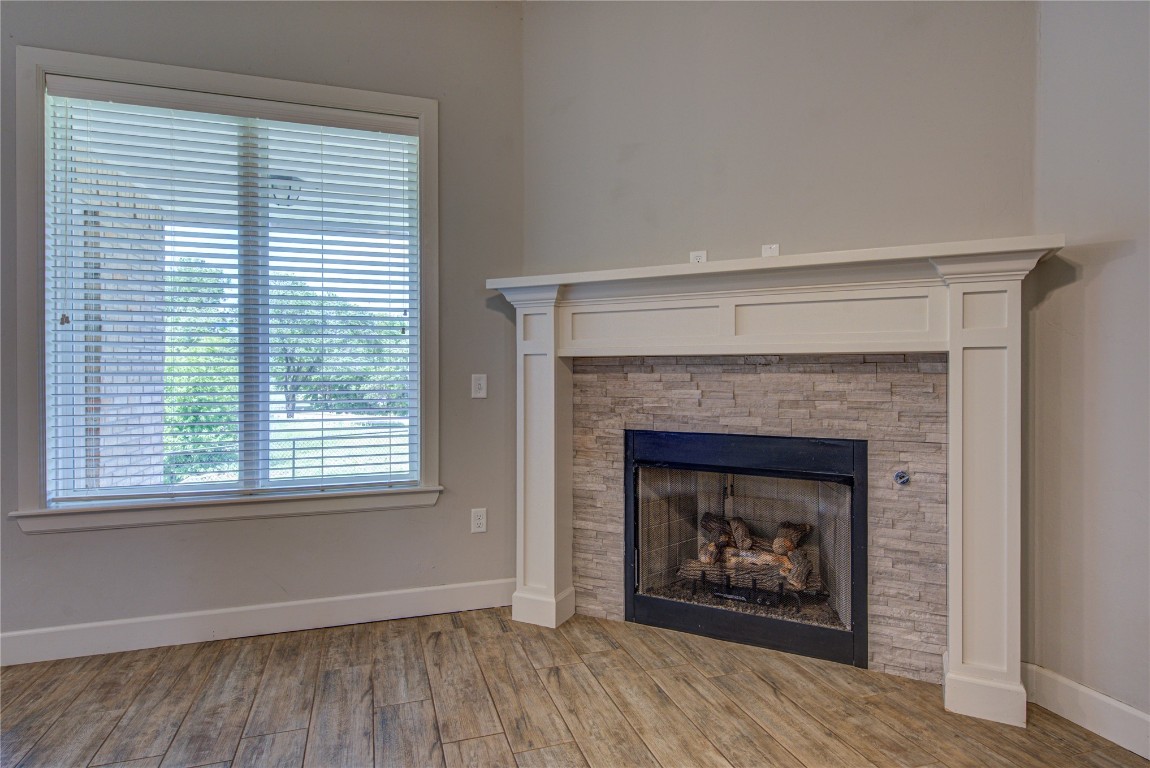 201 Casey Lane, Washington, OK 73093 interior details featuring a fireplace and light hardwood / wood-style flooring