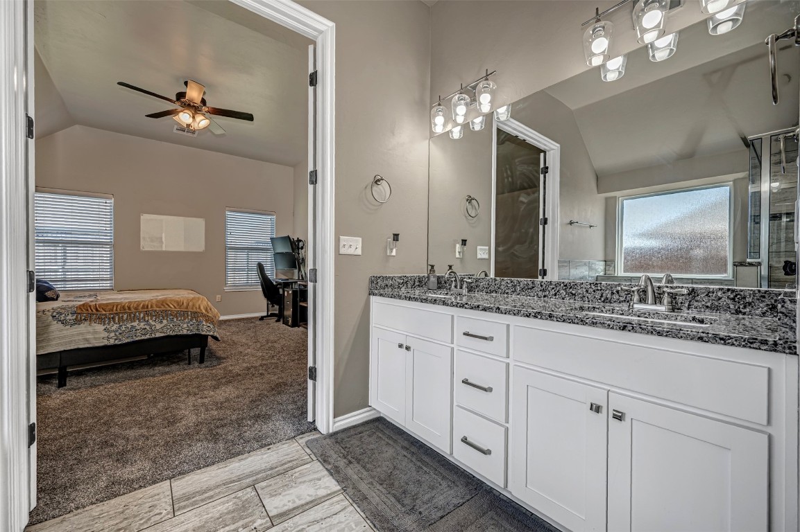 7125 S 156th Street, Edmond, OK 73013 bathroom with tile flooring, ceiling fan, dual vanity, and lofted ceiling