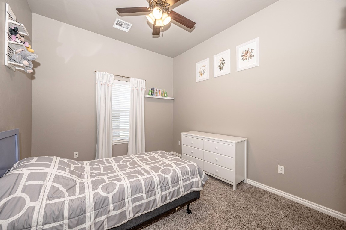 7125 S 156th Street, Edmond, OK 73013 bedroom featuring carpet floors and ceiling fan