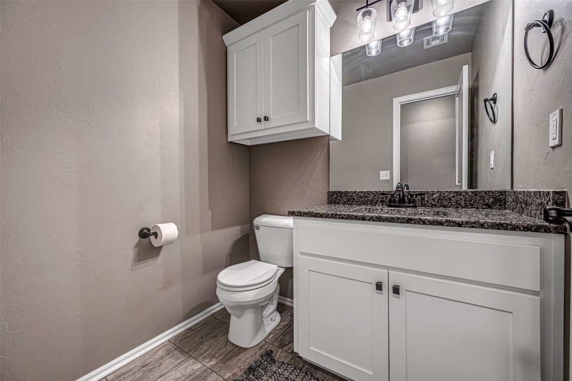 7125 S 156th Street, Edmond, OK 73013 bathroom featuring oversized vanity, toilet, and tile floors