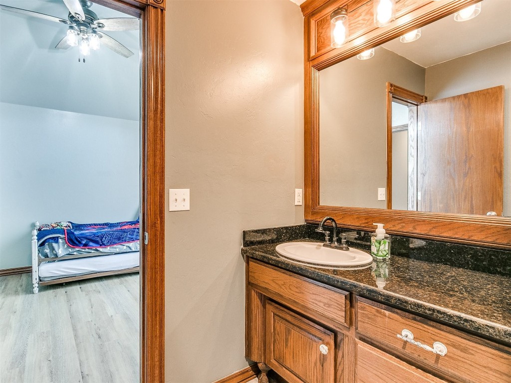 835 County Street 2922, Tuttle, OK 73089 bathroom featuring ceiling fan, hardwood / wood-style floors, and vanity