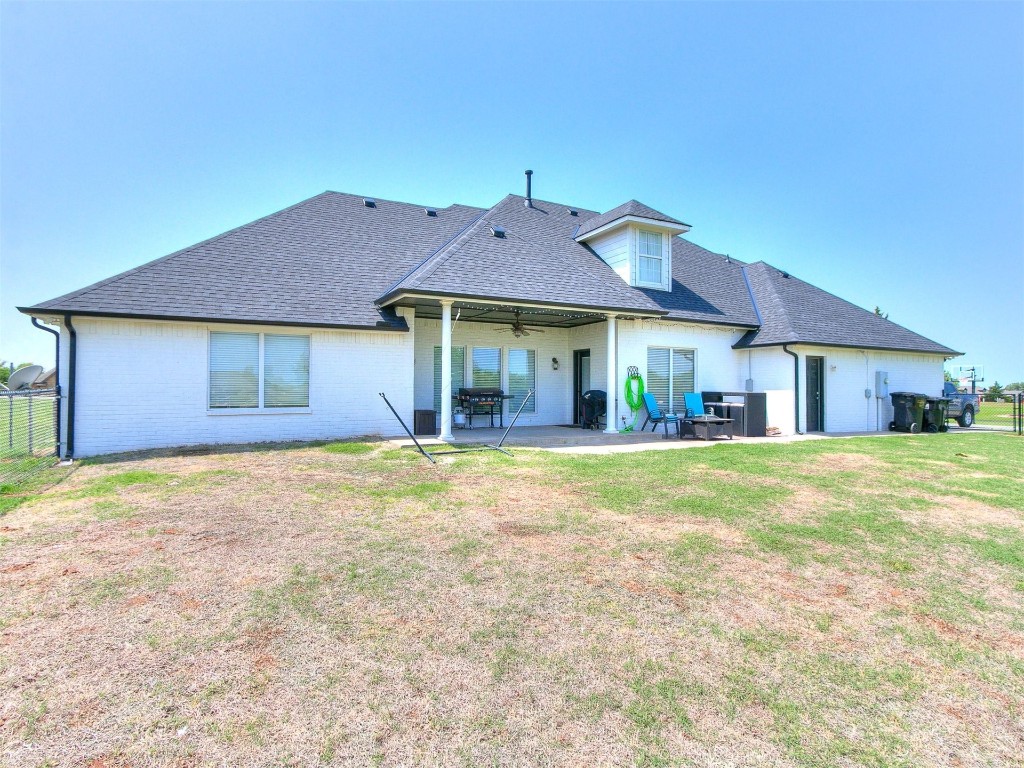 835 County Street 2922, Tuttle, OK 73089 back of property with a lawn and a patio