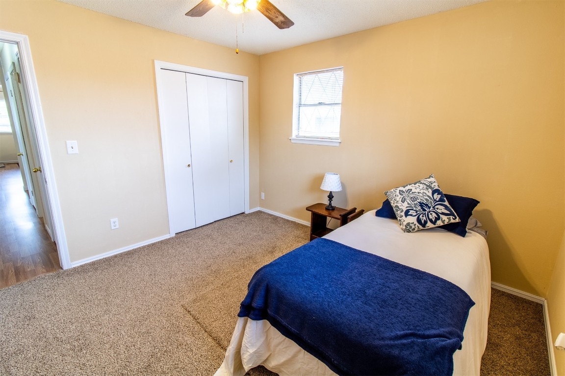 4704 Leslie Drive, Del City, OK 73115 bedroom with a closet, carpet floors, and ceiling fan