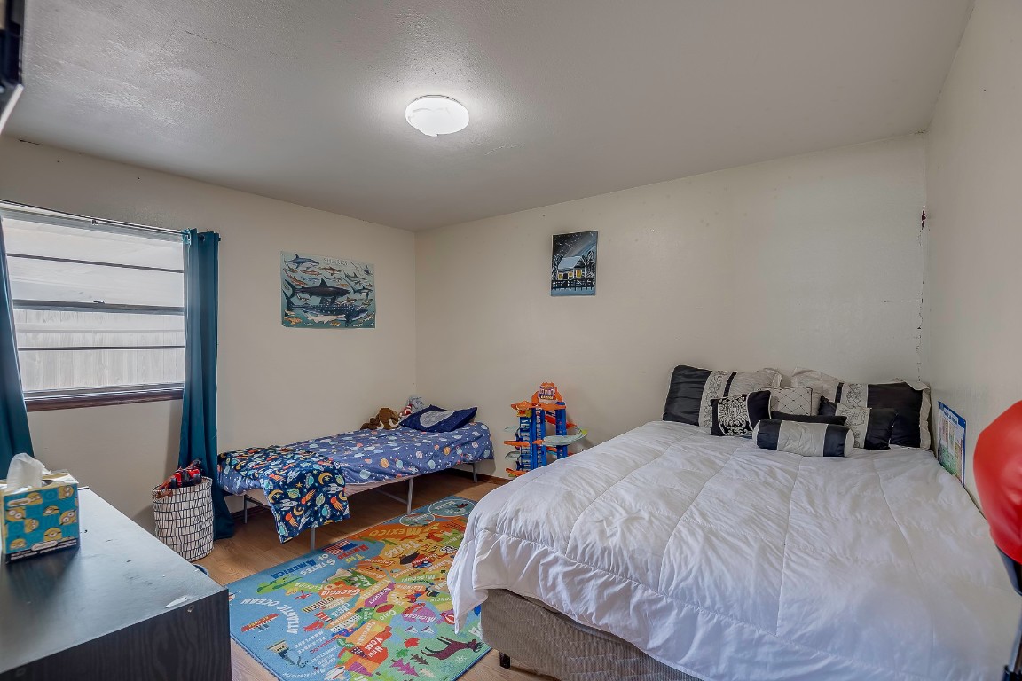 1217 SW 94th Street, Oklahoma City, OK 73139 bedroom with wood-type flooring