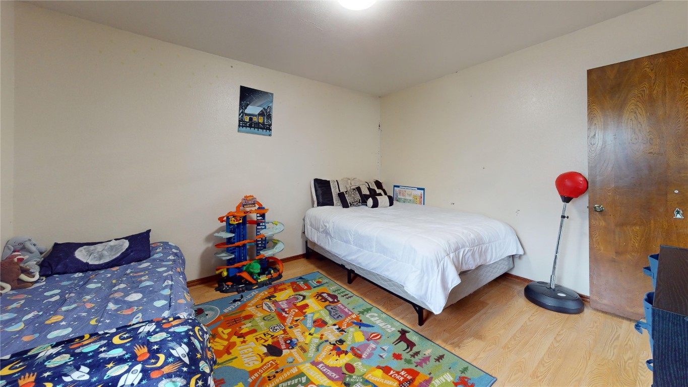 1217 SW 94th Street, Oklahoma City, OK 73139 bedroom featuring hardwood / wood-style flooring