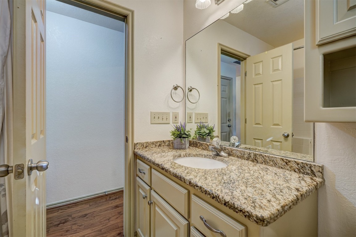 928 Heather Glen Terrace, Norman, OK 73072 bathroom featuring hardwood / wood-style floors and vanity