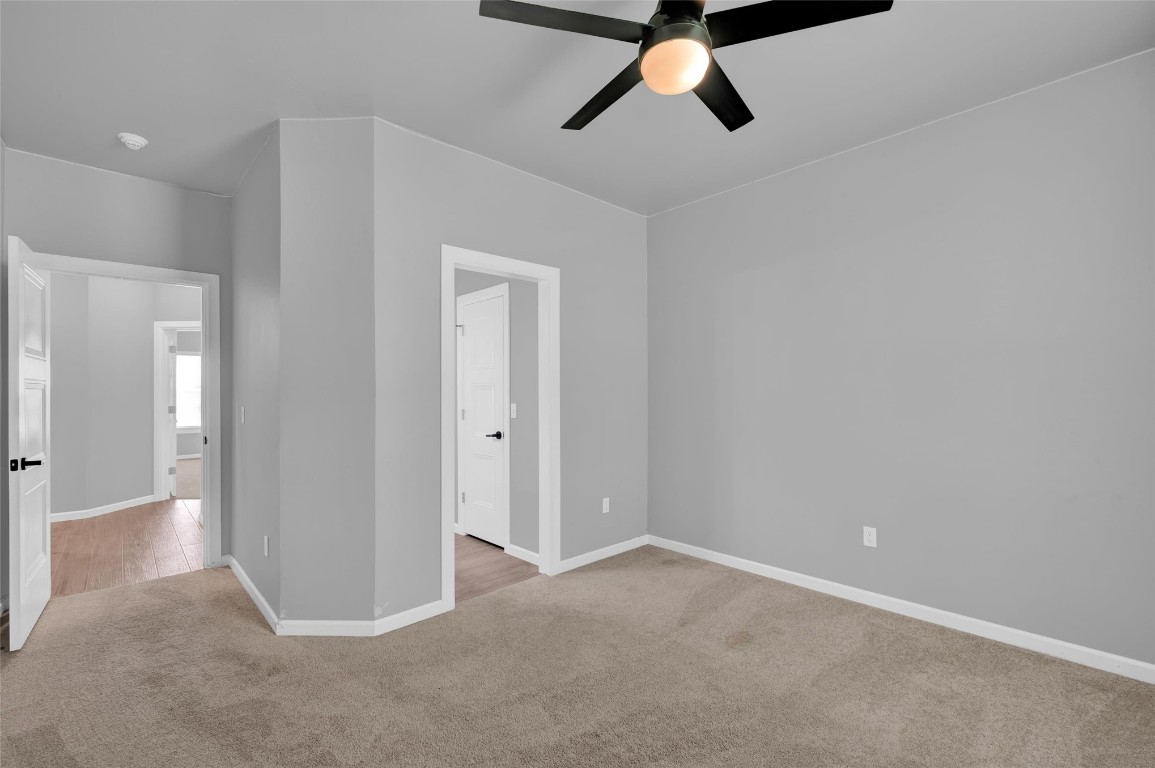 2704 Woodlawn Court, Shawnee, OK 74804 unfurnished bedroom with ceiling fan and carpet