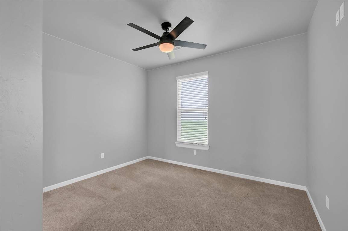 2704 Woodlawn Court, Shawnee, OK 74804 carpeted empty room with ceiling fan