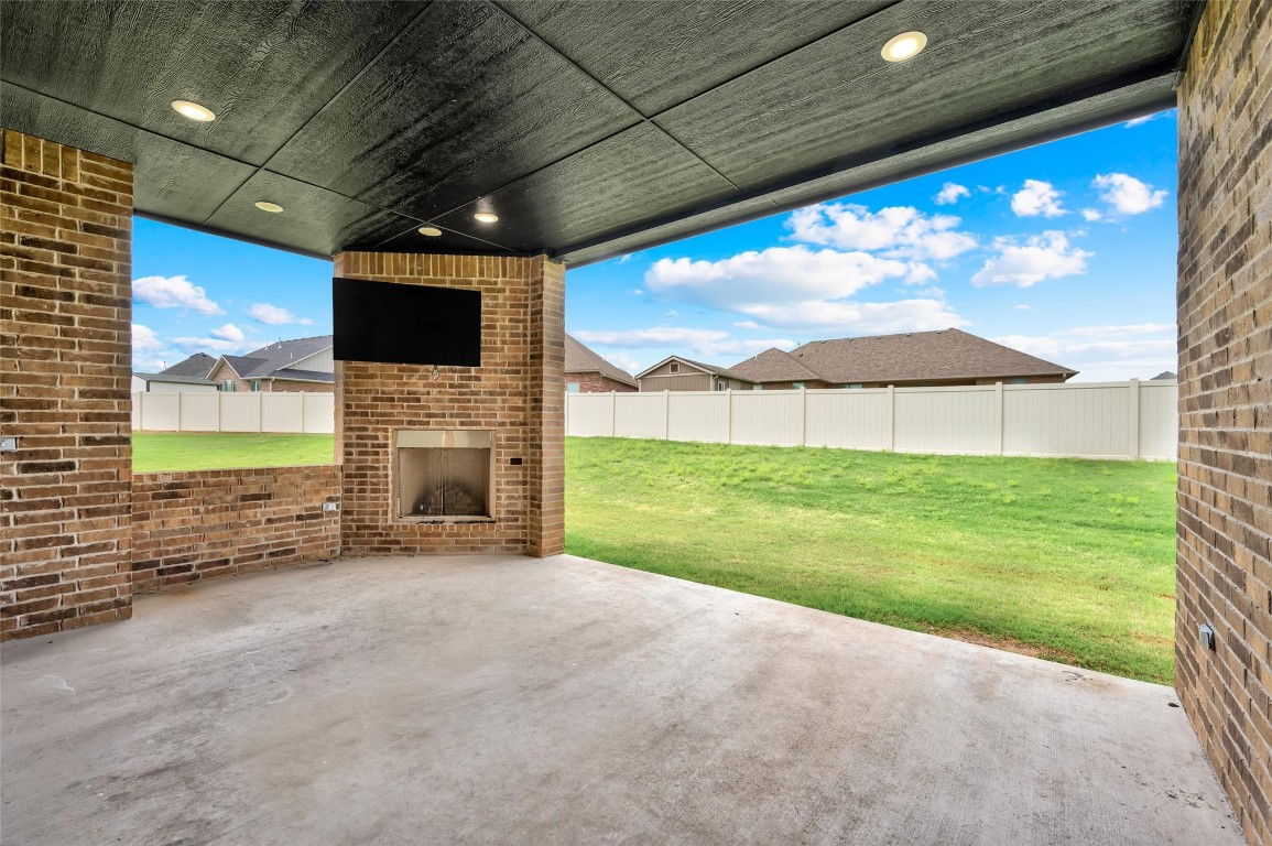 2704 Woodlawn Court, Shawnee, OK 74804 view of patio with an outdoor brick fireplace