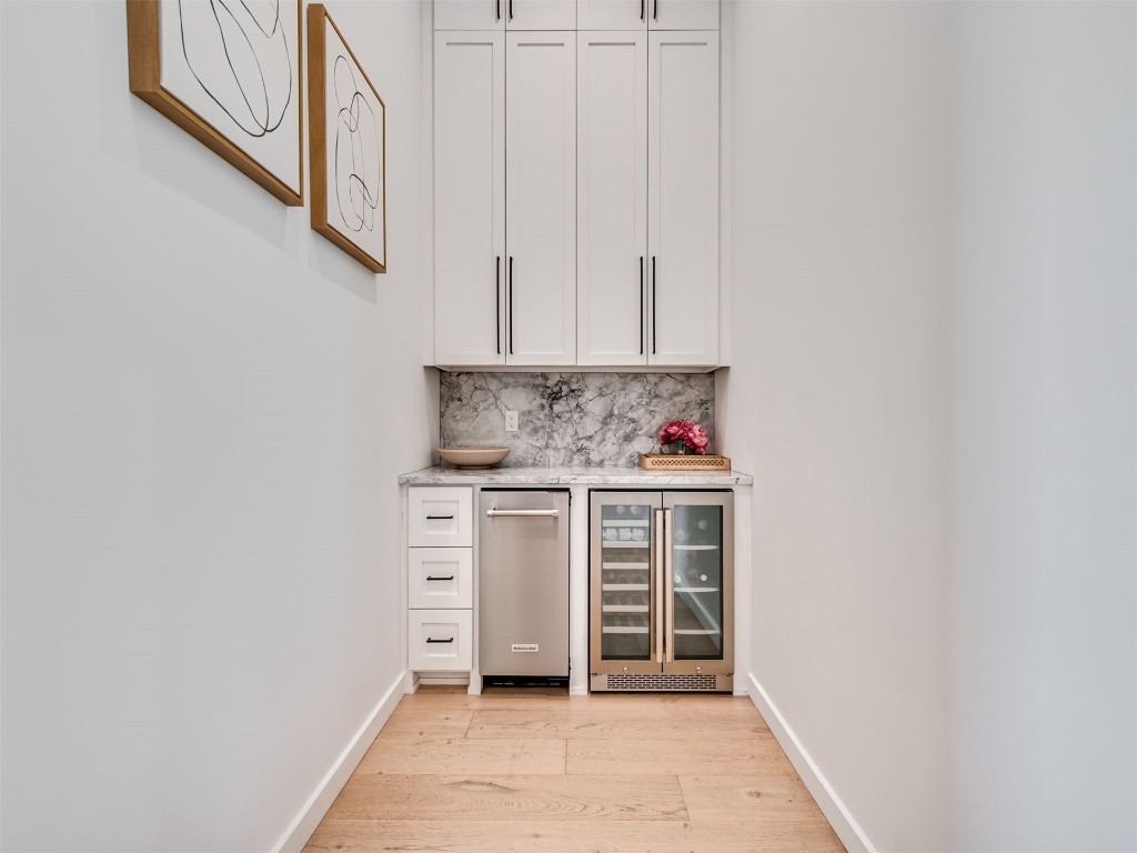 18320 108th Street, Lexington, OK 73051 bar featuring white cabinets, tasteful backsplash, wine cooler, and light wood-type flooring