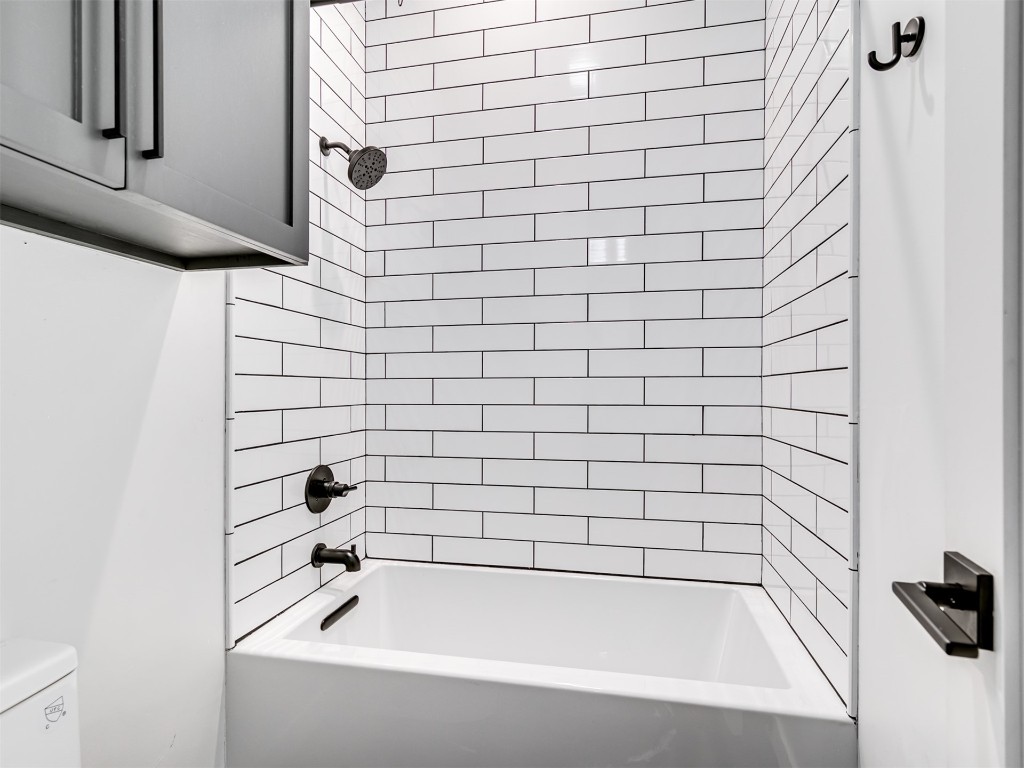 18320 108th Street, Lexington, OK 73051 bathroom featuring tiled shower / bath combo and toilet