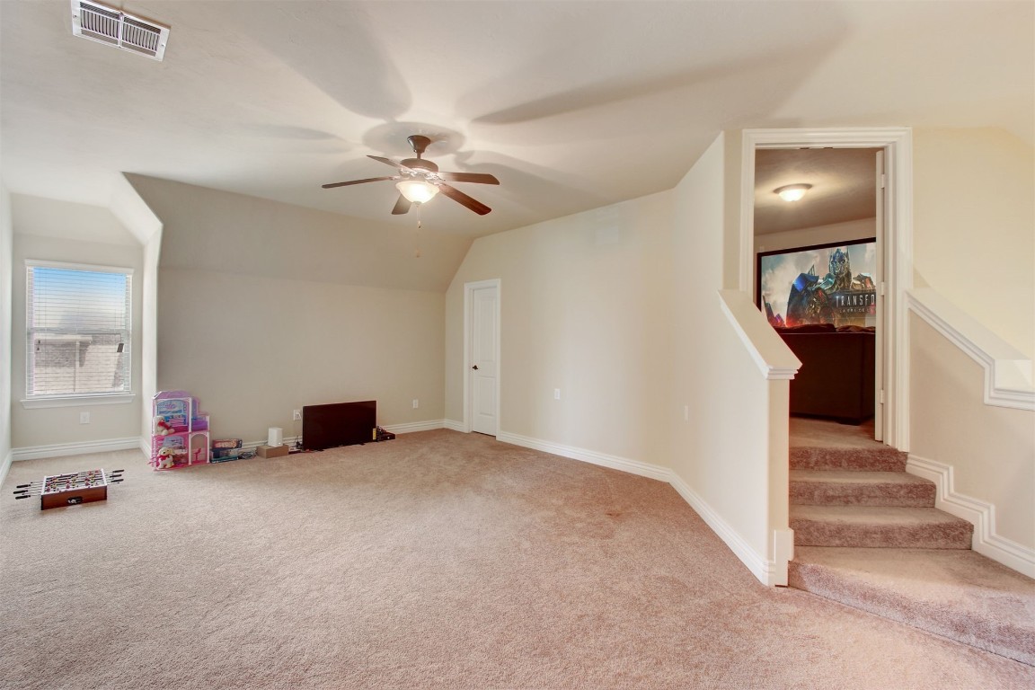 2308 NW 156th Street, Edmond, OK 73013 carpeted bedroom featuring ceiling fan