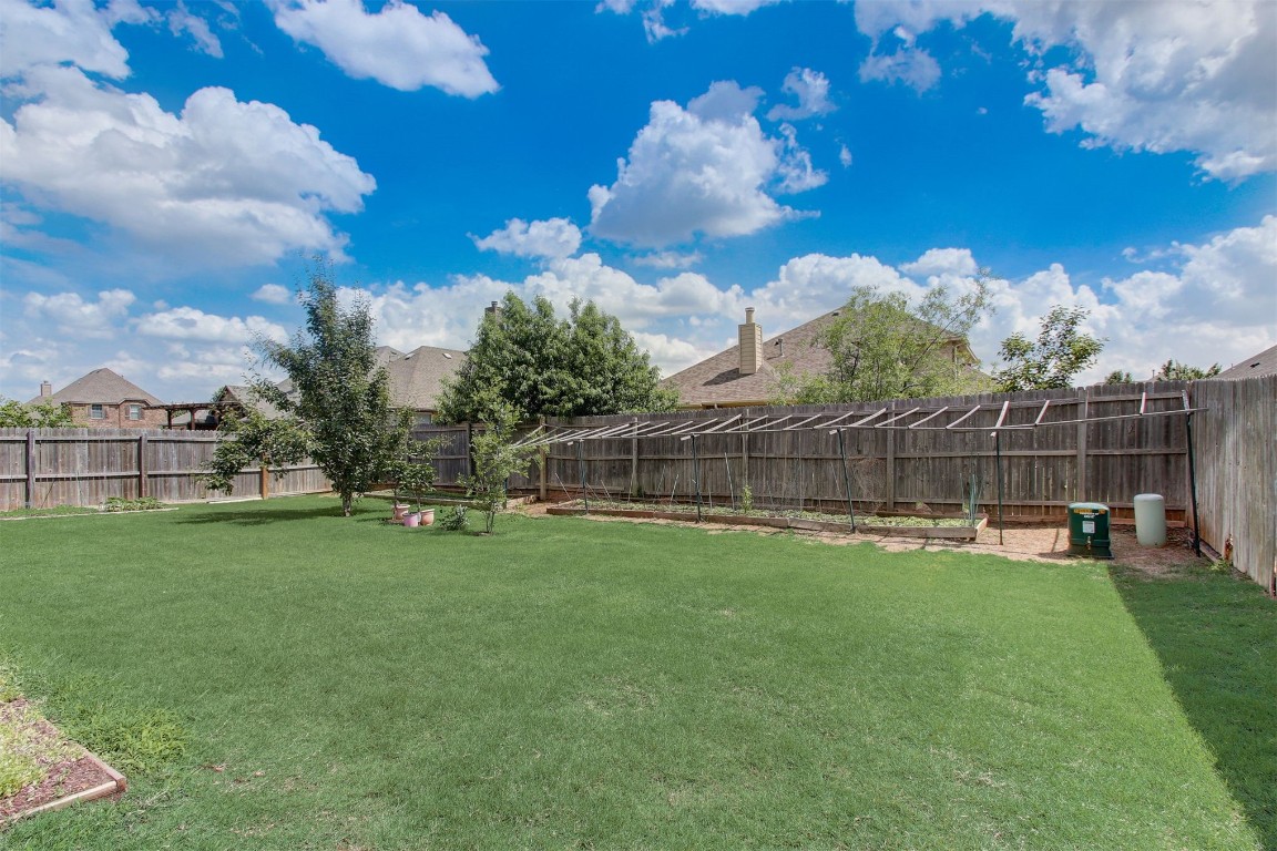 2308 NW 156th Street, Edmond, OK 73013 view of basketball court featuring a lawn