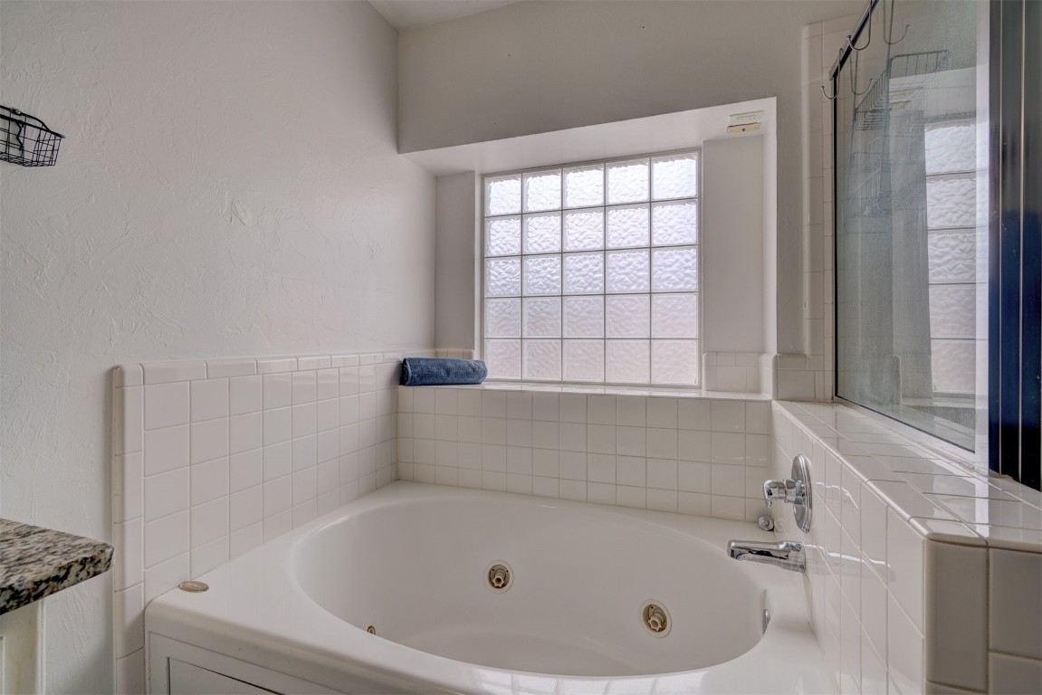3509 Shona Way, Norman, OK 73069 bathroom featuring a bath to relax in