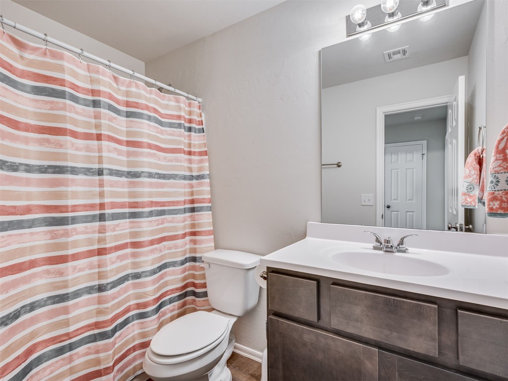 10009 Wessex Drive, Yukon, OK 73099 bathroom with oversized vanity and toilet