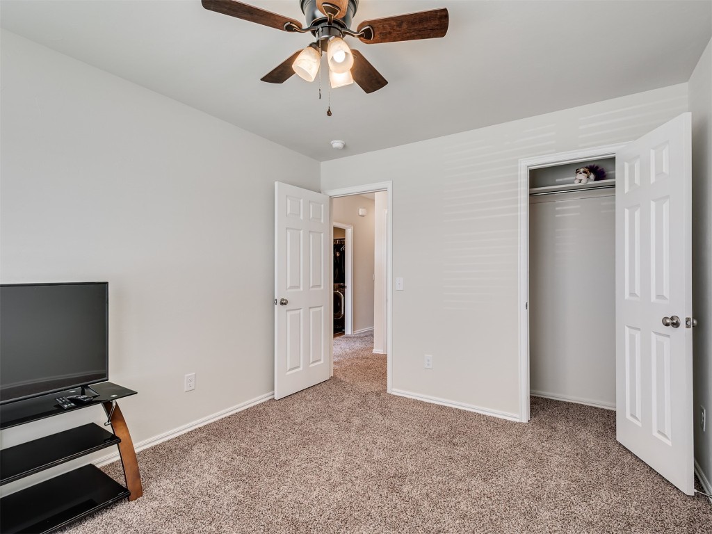 10009 Wessex Drive, Yukon, OK 73099 carpeted bedroom with a closet and ceiling fan