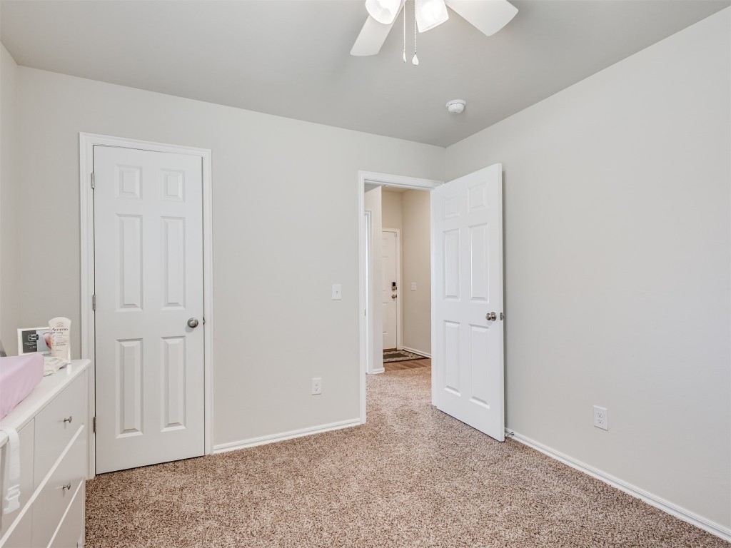 10009 Wessex Drive, Yukon, OK 73099 unfurnished bedroom with light carpet and ceiling fan