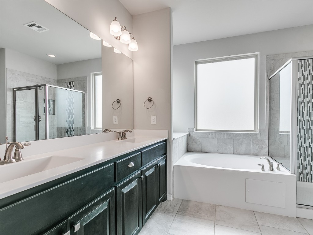 2508 Austin Glen Court, Yukon, OK 73099 bathroom featuring a wealth of natural light, tile flooring, dual vanity, and plus walk in shower