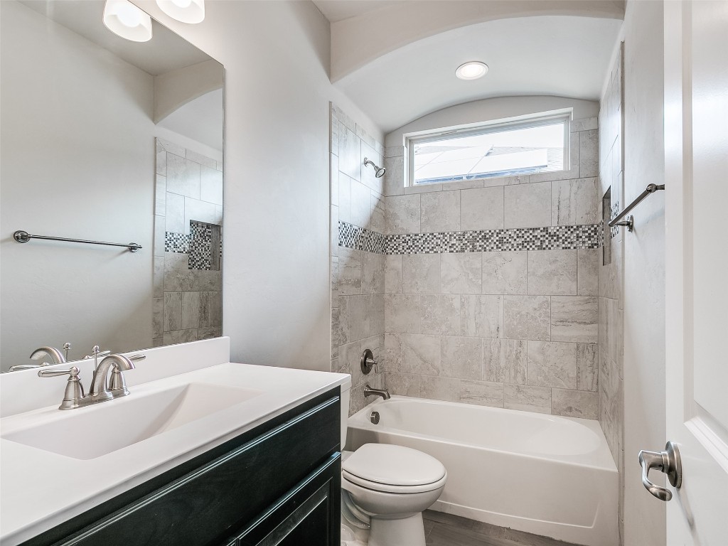 2508 Austin Glen Court, Yukon, OK 73099 full bathroom with tiled shower / bath, vanity, and toilet