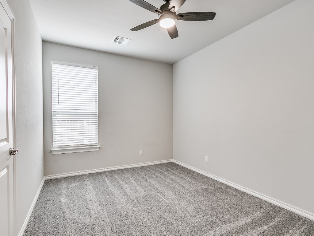 2508 Austin Glen Court, Yukon, OK 73099 carpeted empty room with plenty of natural light and ceiling fan