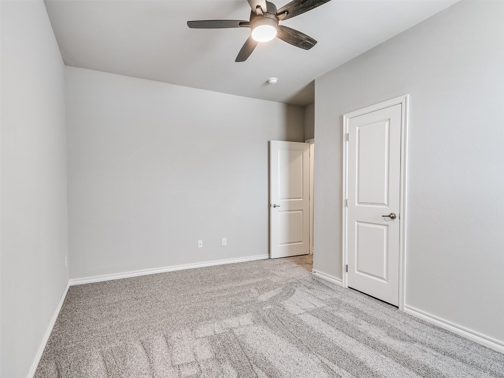 2508 Austin Glen Court, Yukon, OK 73099 carpeted spare room with ceiling fan