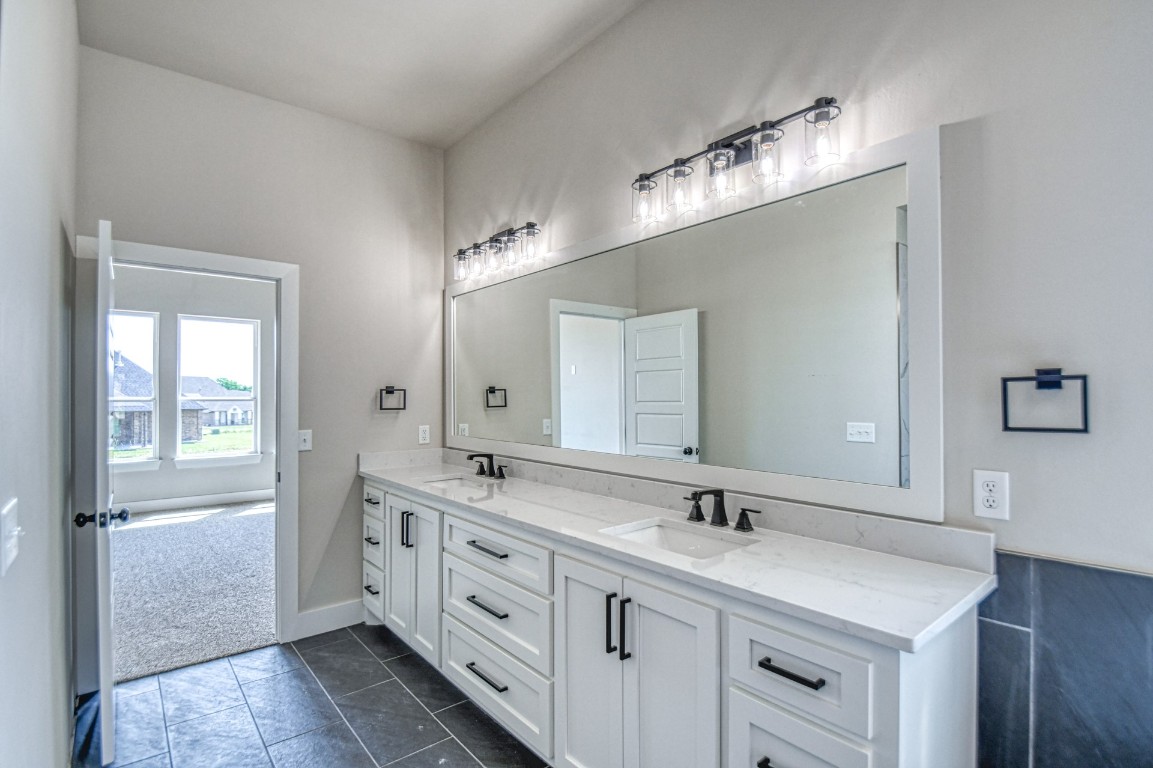1102 Collis Way, Newcastle, OK 73065 bathroom with a wealth of natural light, vanity, tile floors, and tile walls