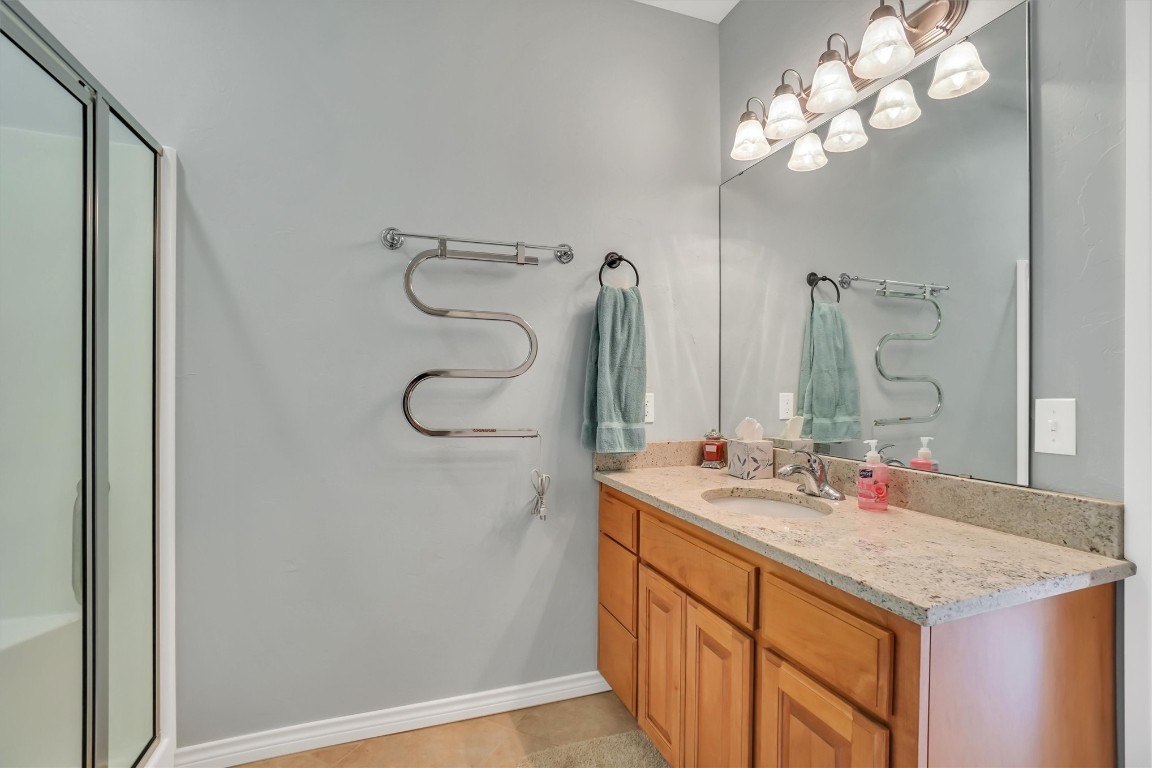3901 Heritage Trail, Altus, OK 73521 bathroom featuring tile floors and vanity with extensive cabinet space