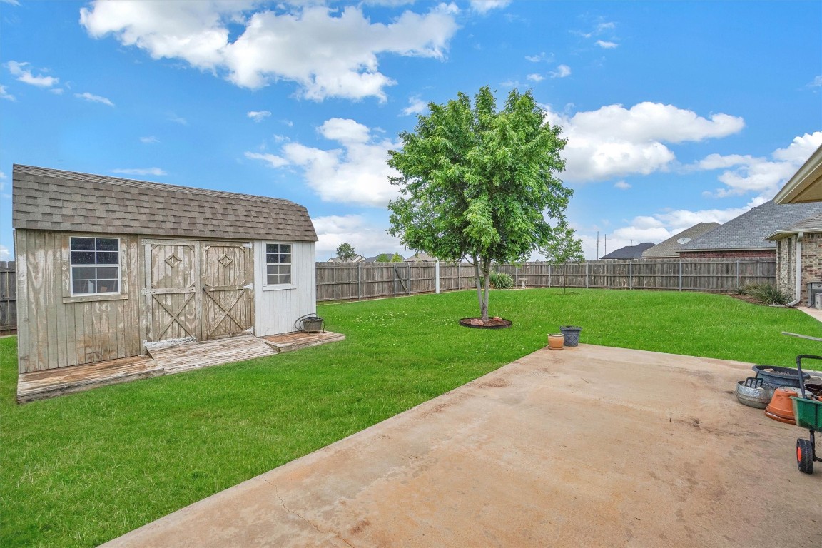 3901 Heritage Trail, Altus, OK 73521 view of yard featuring a patio and a storage shed