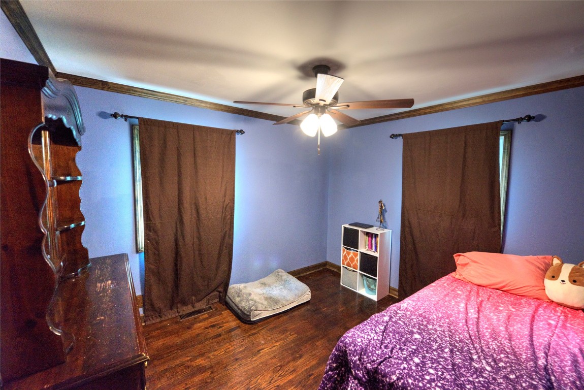 717 W Washington Street, Purcell, OK 73080 bedroom featuring dark hardwood / wood-style floors and ceiling fan