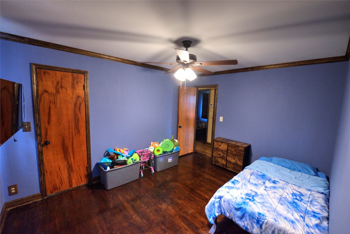 717 W Washington Street, Purcell, OK 73080 bedroom with ceiling fan and dark hardwood / wood-style flooring