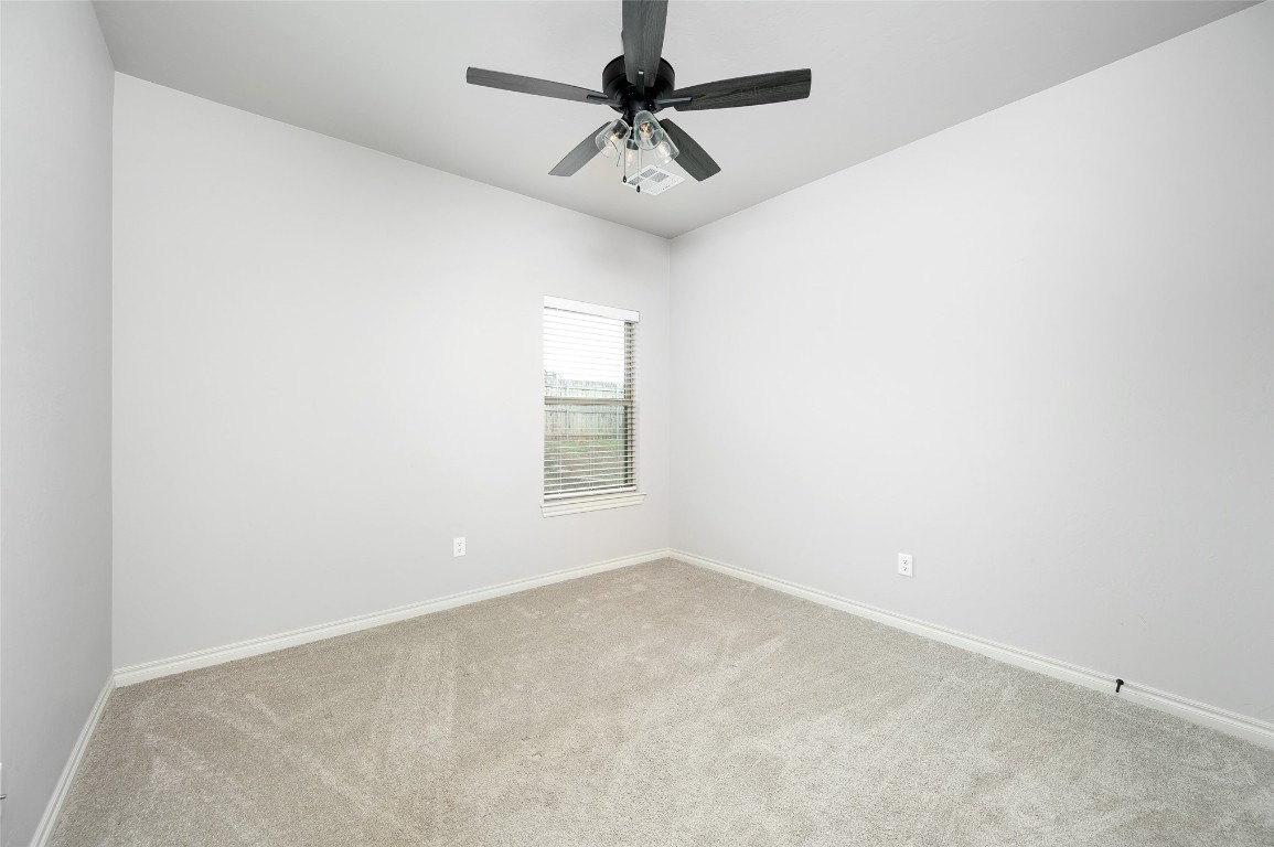 14709 Chambord Drive, Yukon, OK 73099 spare room featuring ceiling fan and carpet floors
