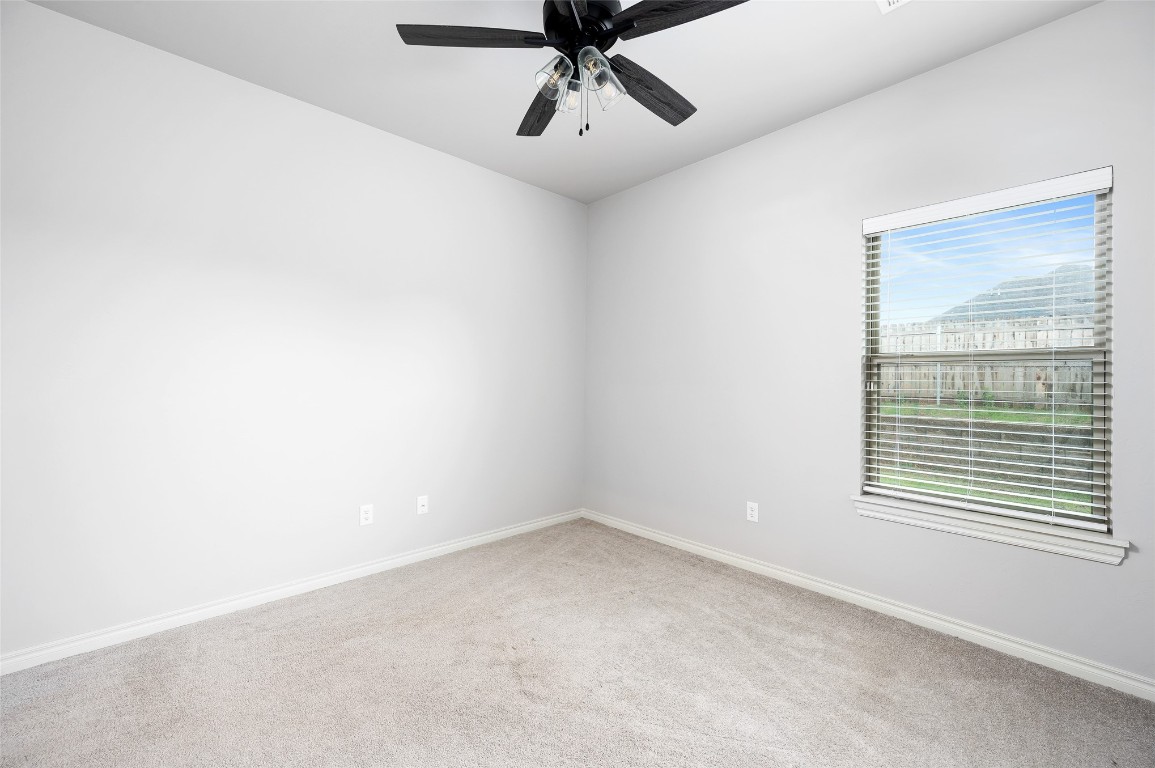 14709 Chambord Drive, Yukon, OK 73099 carpeted spare room featuring ceiling fan