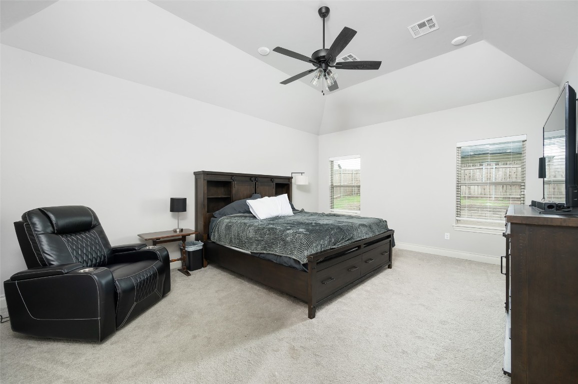 14709 Chambord Drive, Yukon, OK 73099 carpeted bedroom with ceiling fan and lofted ceiling
