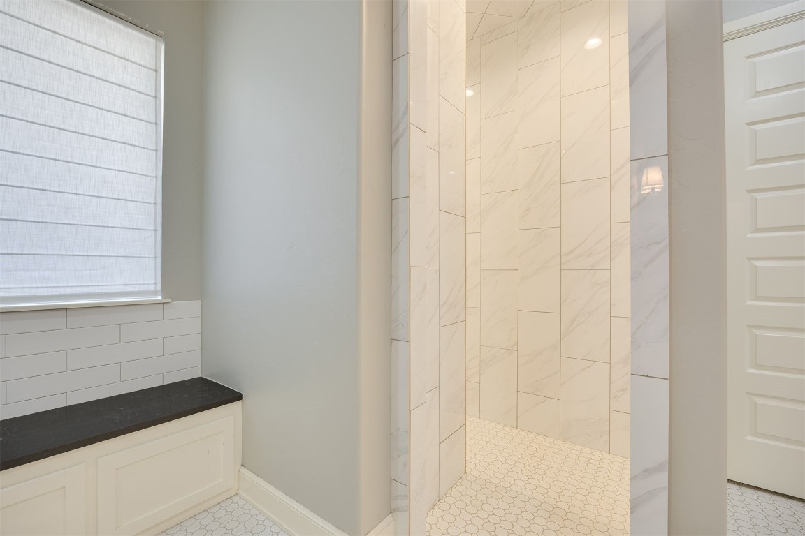 6332 Wentworth Drive, Edmond, OK 73025 bathroom featuring tiled shower and tile flooring
