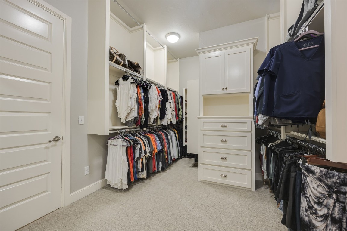 6332 Wentworth Drive, Edmond, OK 73025 walk in closet with light colored carpet