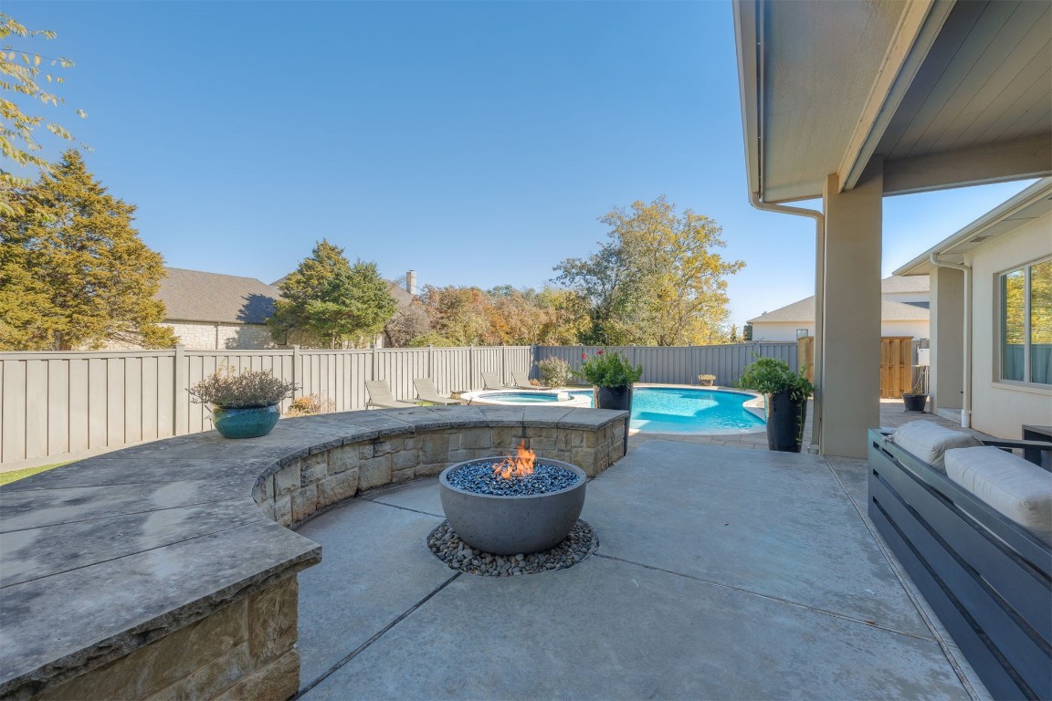 6332 Wentworth Drive, Edmond, OK 73025 view of patio / terrace featuring a pool with hot tub and an outdoor fire pit